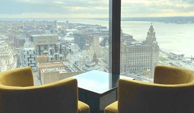 Two yellow seats are placed to look out over the city from the 34th floor, where the restaurant is situated.