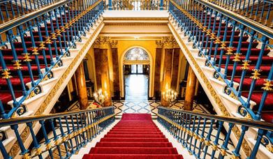 A red carpeted staircase in Liverpool Town Hall.