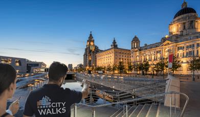The Liverpool waterfront with people on a tour.