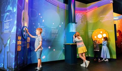 Several children exploring an exhibition