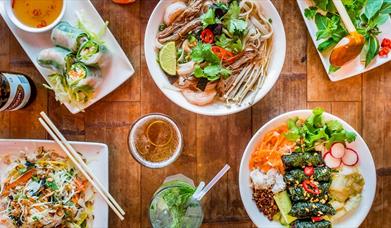 Vietnamese colourful dishes including ramen, noodles, ice teas and pine leaves